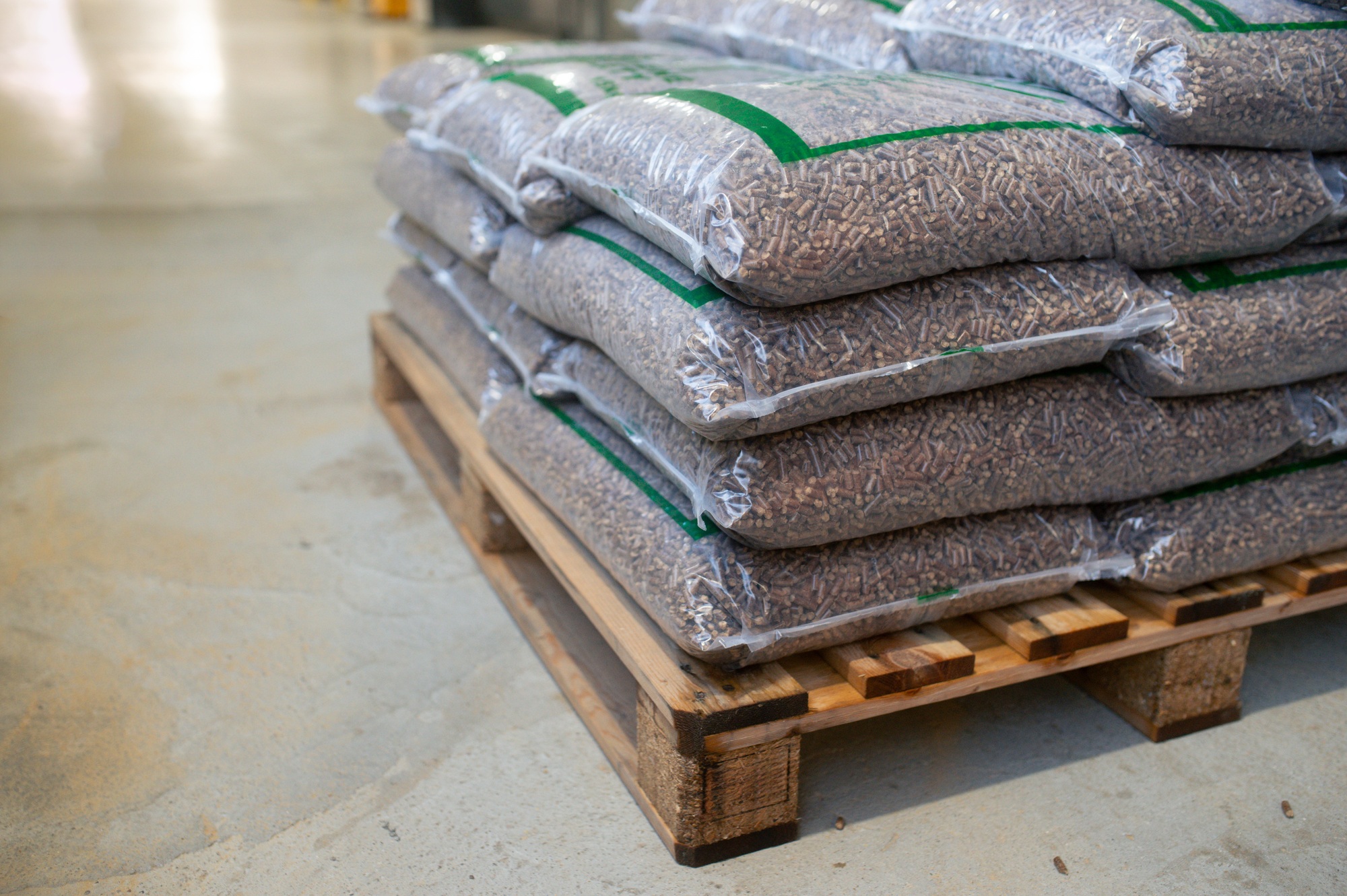 Bags with wood pellets, pellet fuels manufactured in wood pellet line. Reusing wooden industrial